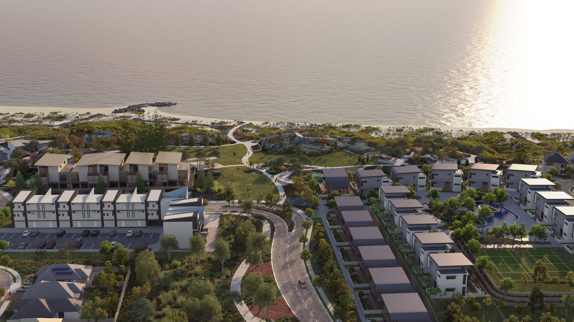 Aerial view of Yanchep's community infrastructure featuring a beachfront residential development with modern buildings, lush green spaces, and pathways near the ocean