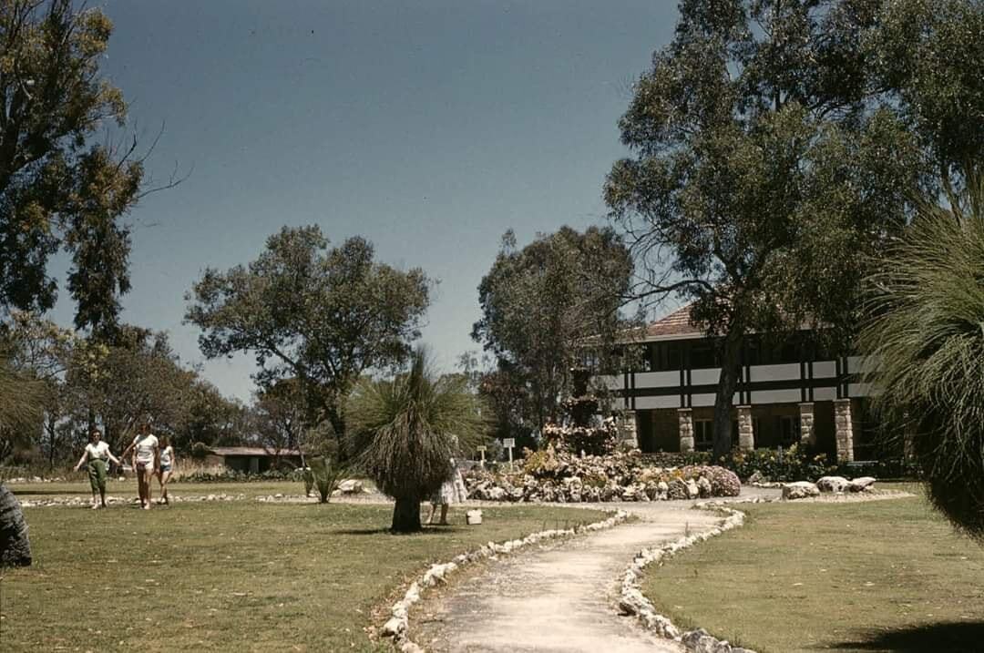 A historic photo of Yanchep land showing visitors walking along a garden path