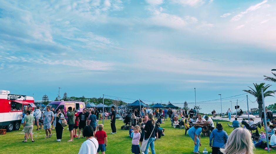 Yanchep Pop-Up with market stalls and people enjoying coastal summer activities by the sea
