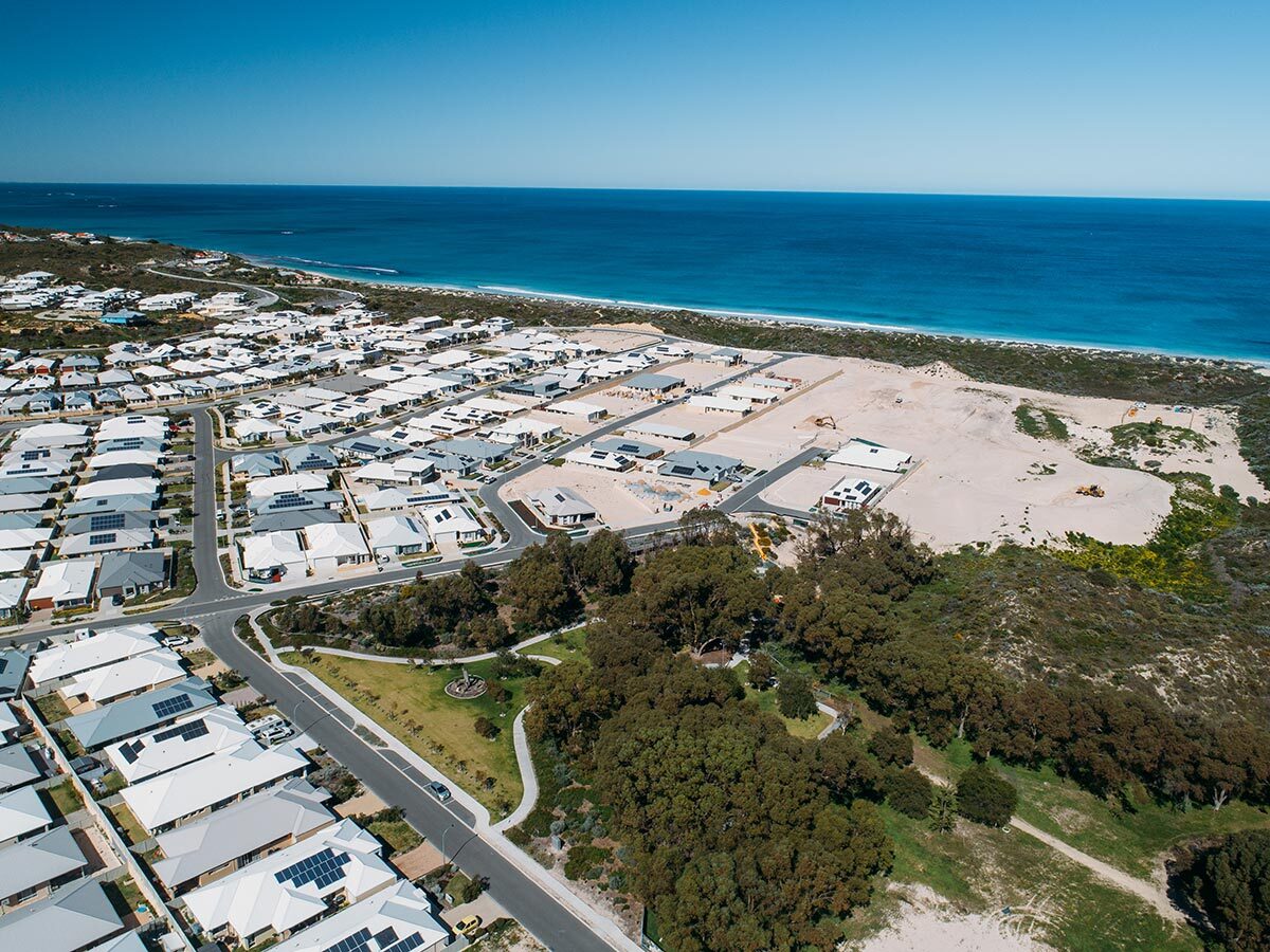Aerial view of a residential area in Yanchep with beachside houses near the ocean